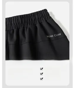 Detail of the elastic waistband and white logo lettering on black men's sports pants