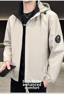 Close-up of beige hooded jacket with black inner lining and sleeve logo patch