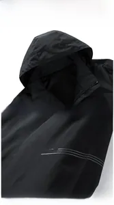 Detail view of black windproof hooded jacket featuring grey letter prints on sleeves