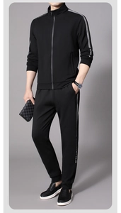 Detail of black sports tracksuit featuring a stand collar jacket and grey side stripes