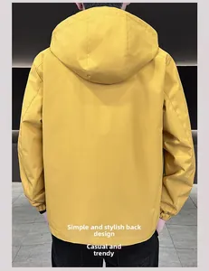 Detail view of the plain back of a bright yellow hooded jacket for men with elastic cuffs