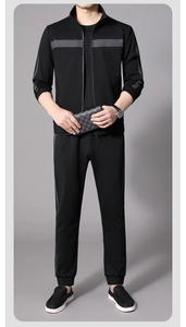 Detail of men's athletic jacket and joggers featuring gray side stripes and ribbed cuffs
