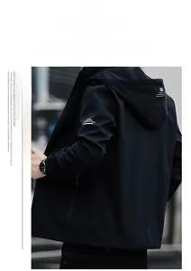 Detail of hooded black windbreaker for men featuring white print and zip-up design