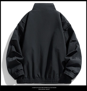Rear view of black outdoor jacket featuring elastic hem and windproof cuffs detail