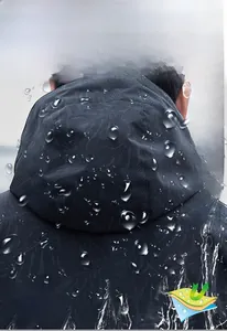 Close-up of waterproof windbreaker fabric showing hydrophobic water droplets texture