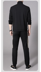 Rear view of black men's sports suit with ivory side stripes and a stand collar jacket