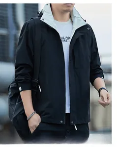 Detail of men's black hooded windbreaker with cream lining and zipper closure
