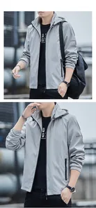 Close-up of a grey hooded tech jacket with elastic cuffs and sleeve logo detail