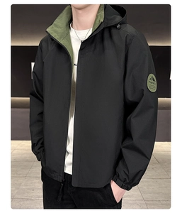 Detail of hooded jacket with windproof black fabric, army green lining and sleeve badge