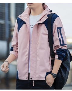 Detail of hooded jacket featuring pink and navy color blocking and velcro adjustable cuffs