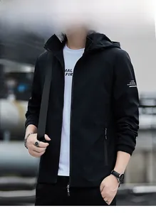Detail of black men's casual hooded jacket with white lettering on sleeve cuff