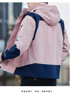 Detail of hooded windbreaker jacket with sleeve embroidery and contrast panel design