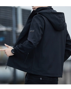 Detail of black hooded jacket featuring side sleeve text and windproof fabric texture
