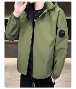 Detail of fruit green hooded jacket with elastic cuffs and Trend+ badge on the sleeve
