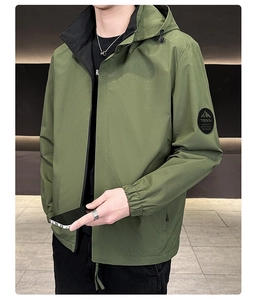 Detail of army green hooded jacket showing the mountain logo arm patch and elastic cuff