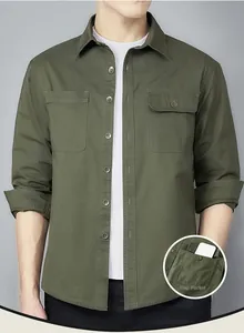 Detailed close-up showing the flap pocket and stitching on the army green work shirt