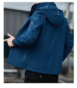 Close-up of windproof hooded jacket in navy blue with white letter print on sleeve