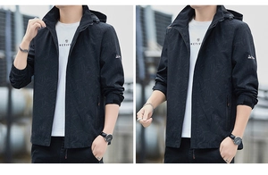 Detail of men's black hooded windbreaker featuring subtle palm leaf patterns and velcro cuffs