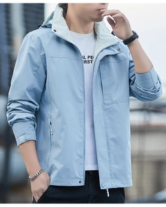 Close-up of light blue windbreaker hood and collar with white contrast lining details
