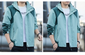 Detail of adjustable drawstring hood and windproof collar on green outdoor jacket