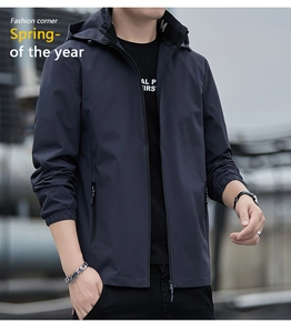 Detailed view of the dark blue hooded windbreaker with zip pockets and elastic cuffs