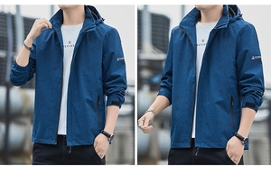Detail view of navy hooded windbreaker with subtle leaf patterns and zipper pockets