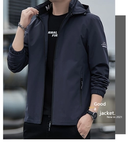 Detail view of navy blue windbreaker jacket featuring elastic cuffs and zipper pockets