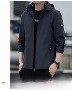 Detail of dark blue windbreaker jacket featuring zip pockets and elasticated cuffs