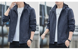 Detailed macro view of dark blue windbreaker featuring subtle leaf patterns and velcro cuffs