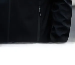 Detailed view of the vertical zipper pocket on black minimalist windproof men's jacket