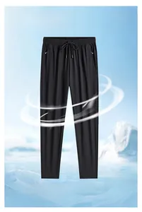 Detail of black ice silk pants showing elastic drawstring waist and side zipper pocket