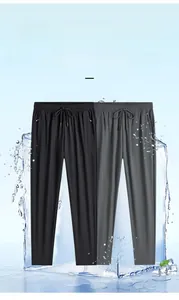 Detail of ice silk casual pants featuring elastic drawstring waist and zippered pockets