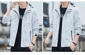 Detail of hooded windbreaker featuring tropical leaf prints and adjustable velcro cuffs