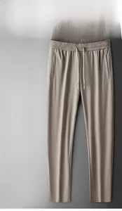 Detail of men's ice silk trousers featuring elastic waist with drawstring and side pockets