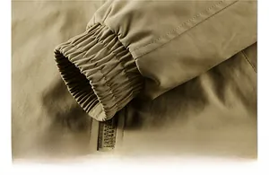 Detail of elastic ribbed cuffs and durable cotton fabric texture on khaki flight jacket