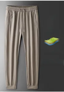 Detail of light khaki ice silk pants featuring breathable mesh and drawstring waistband