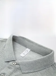 Detail of grey cotton Polo shirt collar with classic ribbed texture and white neck label
