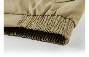 Detail of khaki jacket ribbed hem showing durable twill cotton fabric and elastic cuff