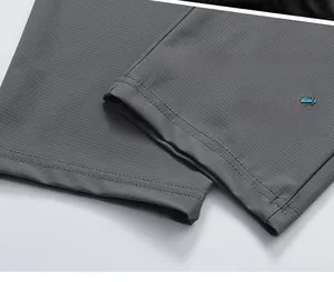 Détail du bas de pantalon en soie glacée gris foncé avec texture micro-grille et coutures