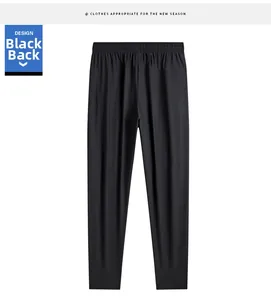 Detail view of the elastic waistband and back design of black ice silk pants