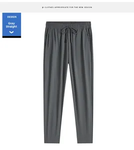 Detail of dark grey ice silk sports pants featuring zipper pockets and drawstring waist