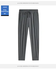 Detail of grey ice silk jogger pants featuring zip pockets and adjustable drawstring