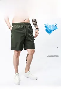 Detail view of dark green cargo shorts with elastic drawstring waist and textured fabric