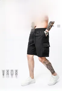 Detail of black cargo shorts with elastic drawstring waist and large flap pockets
