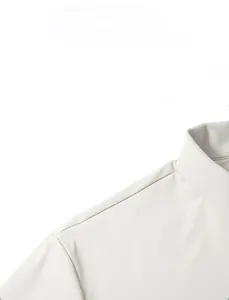 Detail view of the ergonomic shoulder tailoring and fine fabric texture on a men's polo shirt