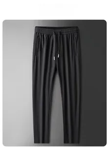 Detail view of black straight-leg ice silk pants with elastic drawstring waist and hidden pockets