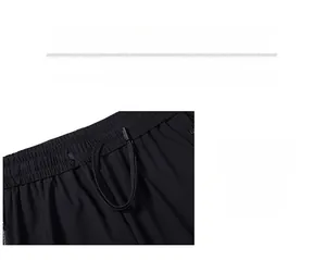 Detail of men's black ice silk trousers showing elastic waistband and drawstring