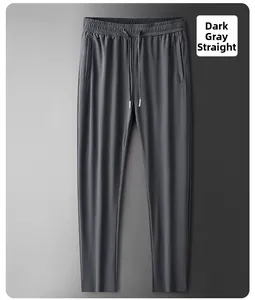 Detail view of dark grey ice silk trousers featuring zipper pockets and elastic drawstring waist