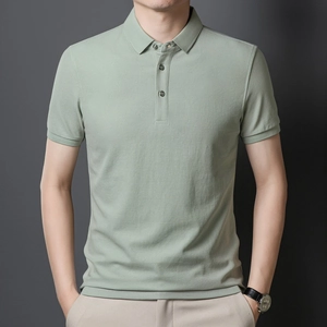 Detail view of sage green polo shirt featuring ribbed collar and textured cotton piqué fabric