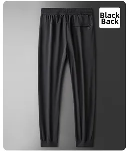 Rear view of black ice silk joggers featuring elastic waist and secure zippered pocket